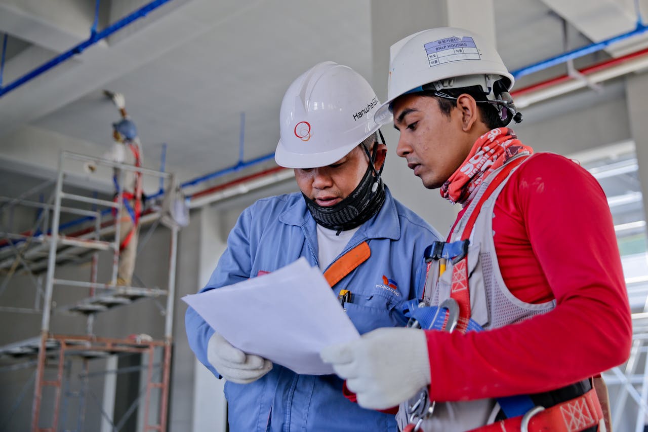 Two NDT engineers reviewing inspection plans at a Queensland construction site